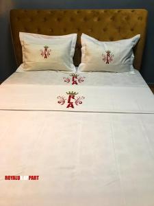 een bed met Chinese karakters op de kussens bij Hôtel appartement luxe in Foumban