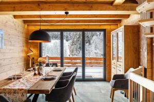 a dining room with a wooden table and chairs at Chalet Aus Holz in Garmisch-Partenkirchen
