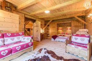 a living room with wooden walls and wooden ceilings at Chalet de Marie proche des Saisies in Queige