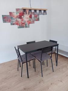 a black table and two chairs in front of a wall at Zentral und ruhig in Auerbach in Auerbach