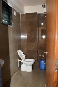 a bathroom with a toilet and a shower at Hotel Bharosa inn Naroda in Ahmedabad
