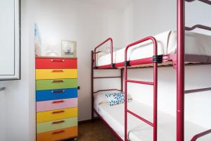a bunk bed room with a bunk bed with colorful drawers at Appartamento da Manzela in Cala Gonone