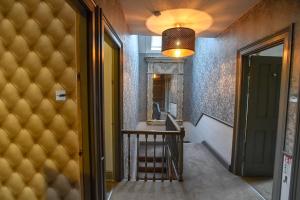 a hallway with a stairway with a light and a stair case at the kingsbury 7even / 8ight in Marlborough