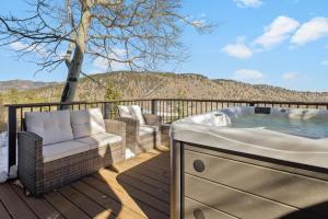 a jacuzzi tub on a deck with a view at Tranquil Rocky MTN Retreat - Hot Tub - Evergreen in Idaho Springs