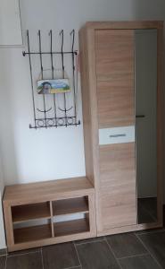 a kitchen with a cupboard and a shelf with a towel at Ferienwohnung Völkner in Hamdorf