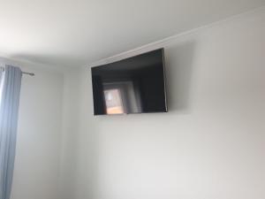 a flat screen tv on the wall of a room at Ferienwohnung Völkner in Hamdorf