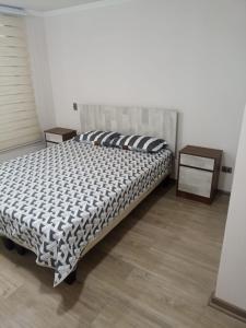 a bed sitting in a room with azeb at Reservas altos de huayquique in Iquique