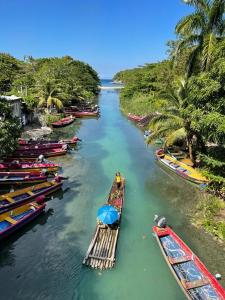a group of boats are lined up in a river at Sand and Tan Beach Hotel in Ocho Rios