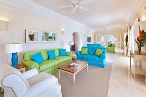a living room with green and blue couches and a table at Royal Westmoreland - High Spirit by Blue Sky Luxury in Saint James