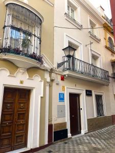 a building with two balconies on a street at Sevilla DosTorres in Seville