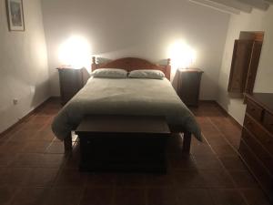 a bedroom with a large bed with two lights on at Casa Tomas in Albox
