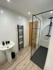 a bathroom with a sink and a mirror at Modern Home with Free Parking Sleeps 6 in Leeds