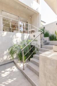 a set of concrete stairs leading to a house at Exquisite And Comfortable Villa Morra Apartment in Asuncion
