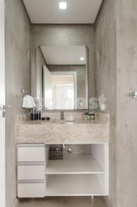 a bathroom with a sink and a mirror at Exquisite And Comfortable Villa Morra Apartment in Asuncion