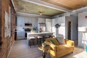 a living room with a couch and a kitchen at Parlor - Explore OTR and DT from Restored 1894 Italianate in Cincinnati +21 photos