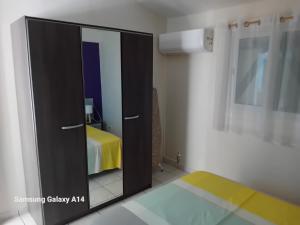 Una puerta negra en una habitación con cama en gîte La Cannaie, en Port-Louis