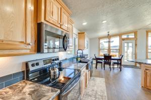 a kitchen with a stove and a dining room at Peaceful Deary Vacation Rental with Deck and Views! 