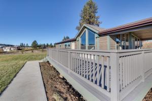a house with a white fence and a porch at Peaceful Deary Vacation Rental with Deck and Views! 