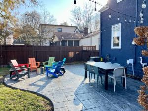 a patio with colorful chairs and tables in a yard at Nokomis Blue in Minneapolis