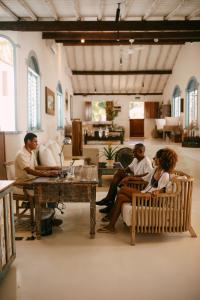 a group of people sitting around a table in a room at Casa La Torre Hotel Boutique in Trancoso