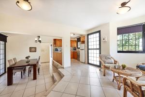a kitchen and living room with a table and chairs at Villa Theo Sapphire by Villa Plus in Lachi