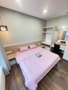 a bedroom with a large bed with pink sheets at Rex-apartment 3room near new Kpj Saradise Bdc in Kuching