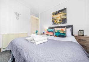 a bedroom with a large bed with white sheets and pillows at Broomfield Apartment by Klass Living Airdrie in Airdrie
