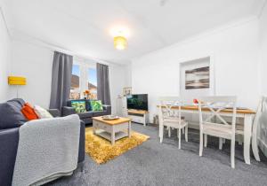 a living room with a couch and a table at Broomfield Apartment by Klass Living Airdrie in Airdrie