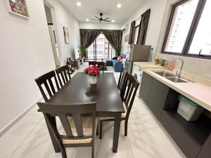 a kitchen and dining room with a table and chairs at Sand Resort @ Country Garden Danga Bay in Johor Bahru