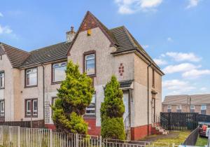 a house with two trees in front of it at Uddingston Apartment by Klass Living in Uddingston