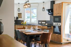 a kitchen with a wooden table and chairs at ARMONA in Brides-les-Bains