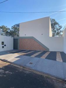 ein weißes Gebäude mit einer Seitentreppe in der Unterkunft Lofts Umuarama Residence in Uberlândia