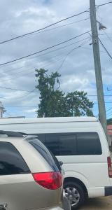 a white van is parked next to a pole at Chaleanor Hotel in Dangriga