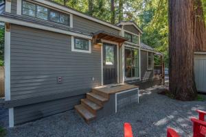 a tiny house with a staircase leading to the front door at Tranquil Redwood Retreat in Guerneville