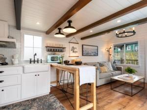 a kitchen and living room with a couch and a table at Tranquil Redwood Retreat in Guerneville