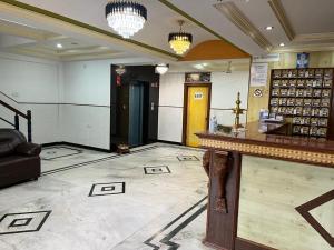 a lobby of a store with a counter and chandeliers at Ganga Sagar Hotel in Bengaluru