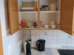 a kitchen with cabinets with utensils and utensils at Alpenloft Theresia in Ferlach