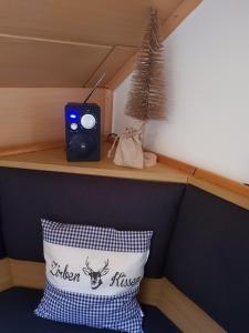 a small room with a pillow and a speaker at Alpenloft Theresia in Ferlach