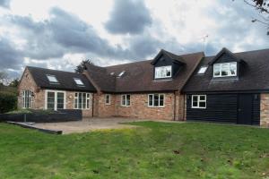 a large brick house with a large yard at Superb 4BD Stay in Wyton and Houghton Village in Wyton