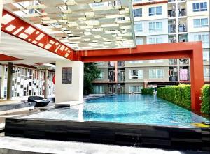 a large swimming pool in the middle of a building at Phuket Kathu - Sunset View in Kathu
