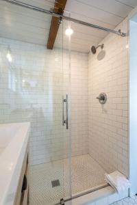 a shower with a glass door in a bathroom at Enchanting Retreat in the heart of Redwoods in Guerneville