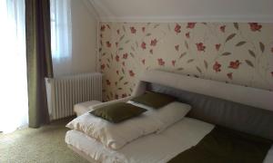 a couch with two pillows on it in a room at Margo Apartman in Fonyód