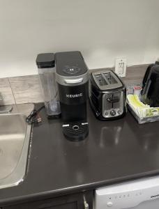 a kitchen counter with a blender and a toaster at Comfortable 3 Bed Basement Unit in Winnipeg