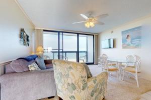 a living room with a couch and a table at Golden Sands 613 in Ocean City