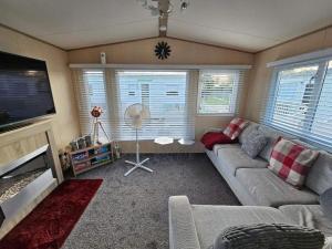 a living room with a couch and a flat screen tv at Jayden in Rhyl