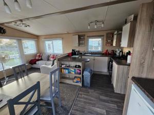 a kitchen and living room of a caravan at Jayden in Rhyl