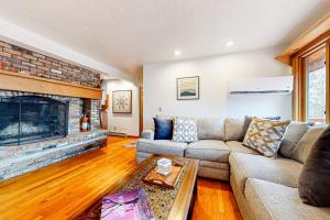 a living room with a couch and a fireplace at Hawk 1 in Pittsfield