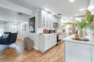 a kitchen with white cabinets and a dining room at Dreamprint Delmar in Naples