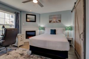 een slaapkamer met een bed, een bureau en een stoel bij Inn of the Four Winds Seaside Oceanfront in Seaside