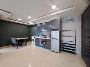 a kitchen with stainless steel appliances and a table at Arcadia Beach Continental by Saowanee in Pattaya South